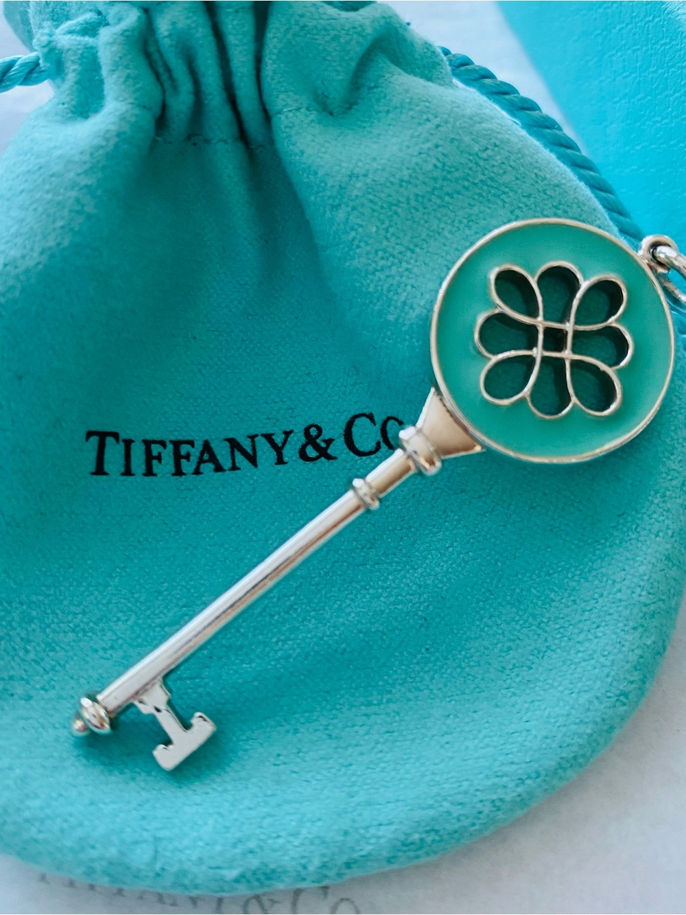 Authentic Tiffany & Co. Blue Enamel Knot Key Pendant.